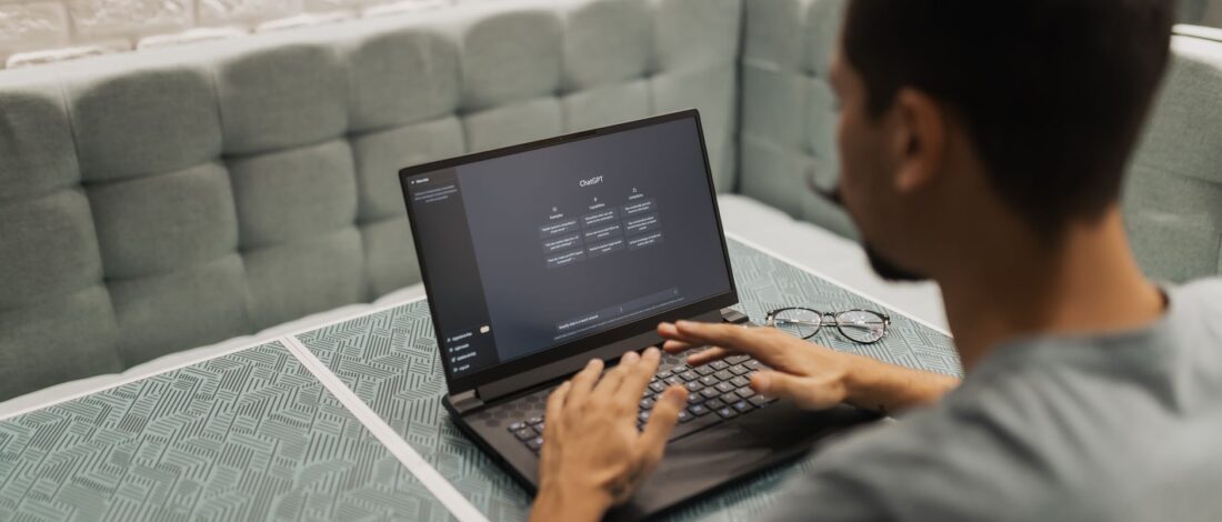A man working on a laptop in a cozy, modern office space with a focus on technology.